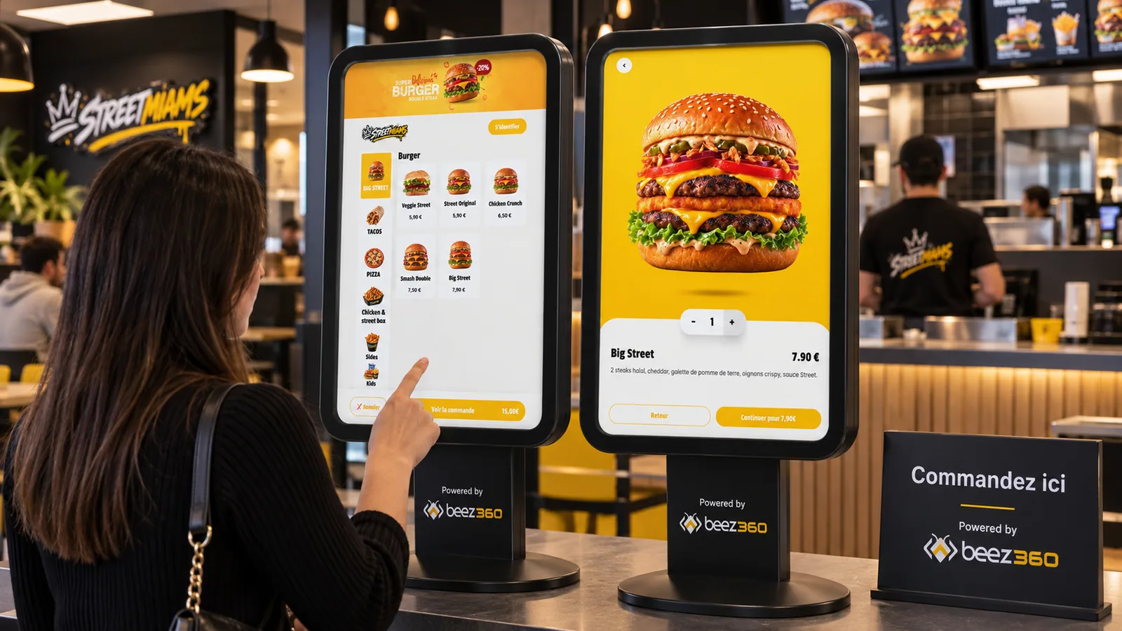 Ordering on BeezKiosk terminals in a fast-food restaurant, with Beez360 branding on the stands.